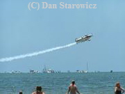 Stunt plane performing near the pier on the North end of Estero Island