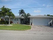 Example of a Cape Coral Gulf access waterfront home in the Cape Coral Yacht Club neighborhood behind a bridge